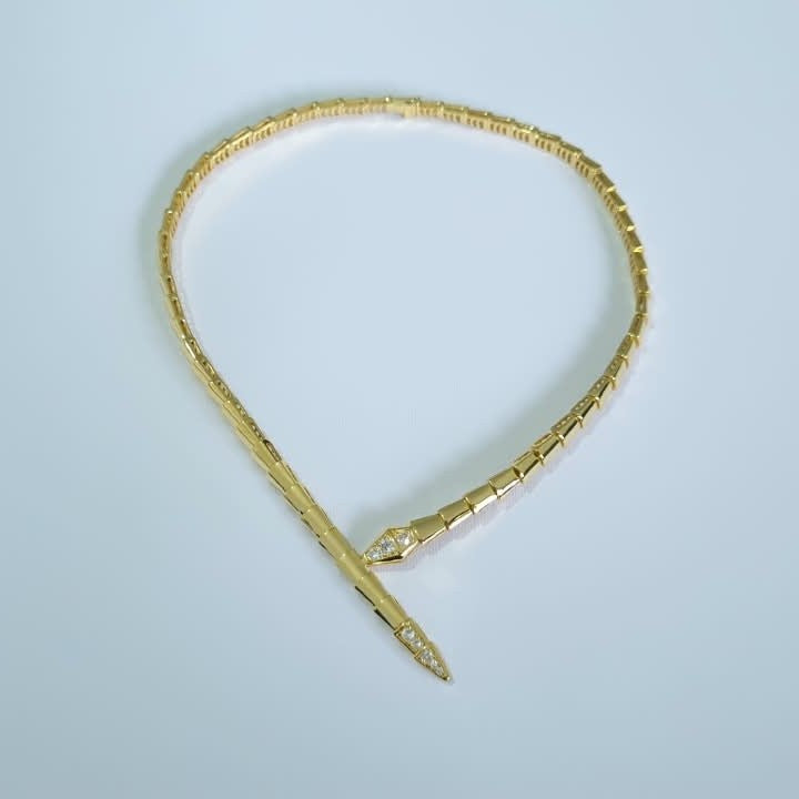 Bulgari Serpenti gold-plated choker necklace with cubic zirconia snake head and tail detail, on white background