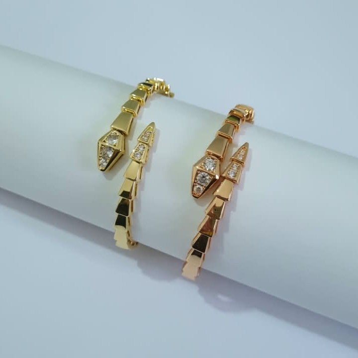 Two Bulgari Serpenti gold & RoseGold-plated wrap bracelets with cubic zirconia snake head detail, size 17, on white background