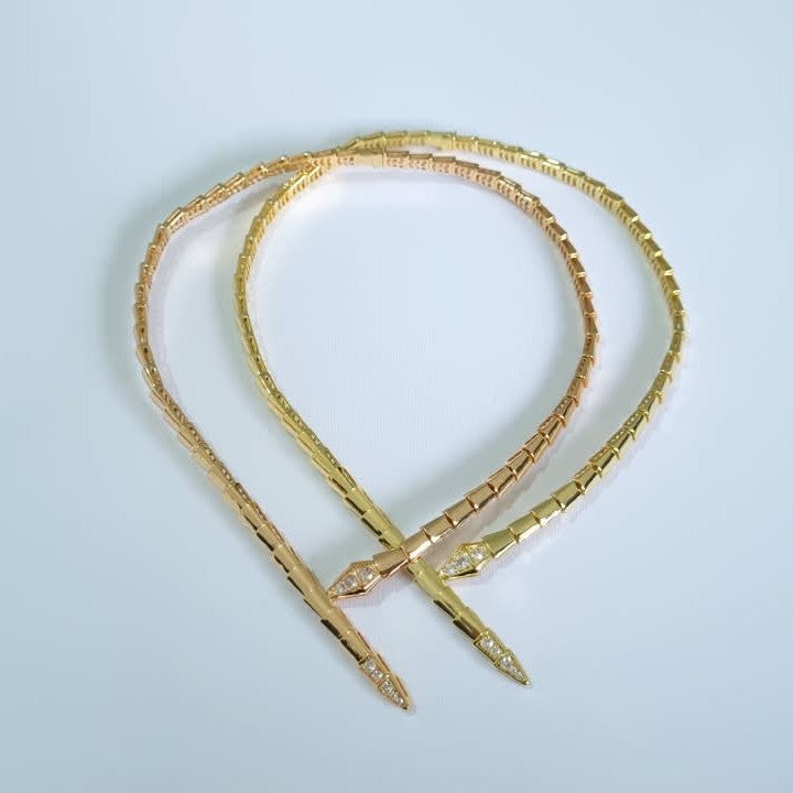 Bulgari Serpenti in two colors gold and RoseGold, choker necklaces with cubic zirconia snake head and tail detail, on white background