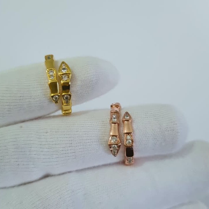 Bulgari Serpenti two colors gold and RoseGold wrap rings with cubic zirconia snake head detail, size 7, on white background