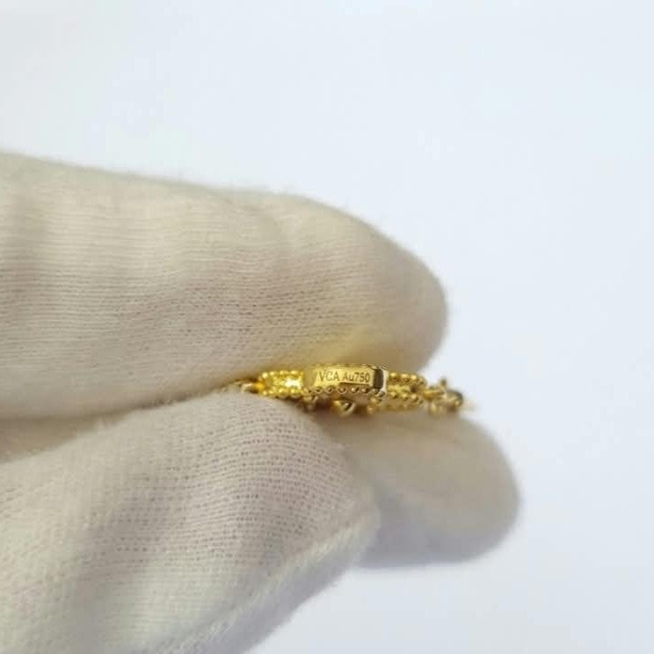 an Cleef Alhambra gold bracelet with an iconic flower motif and gold-plated finish