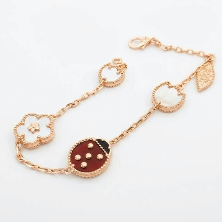 Van Cleef ladybug bracelet with a rose gold chain and carnelian and black onyx ladybug motif