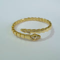 Bulgari Serpenti gold-plated wrap bracelet with cubic zirconia snake head detail, size 17, on white background