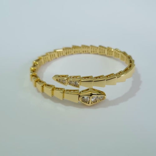 Bulgari Serpenti gold-plated wrap bracelet with cubic zirconia snake head detail, size 17, on white background