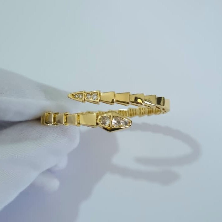 Bulgari Serpenti gold-plated wrap bracelet with cubic zirconia snake head detail, size 17, on white background