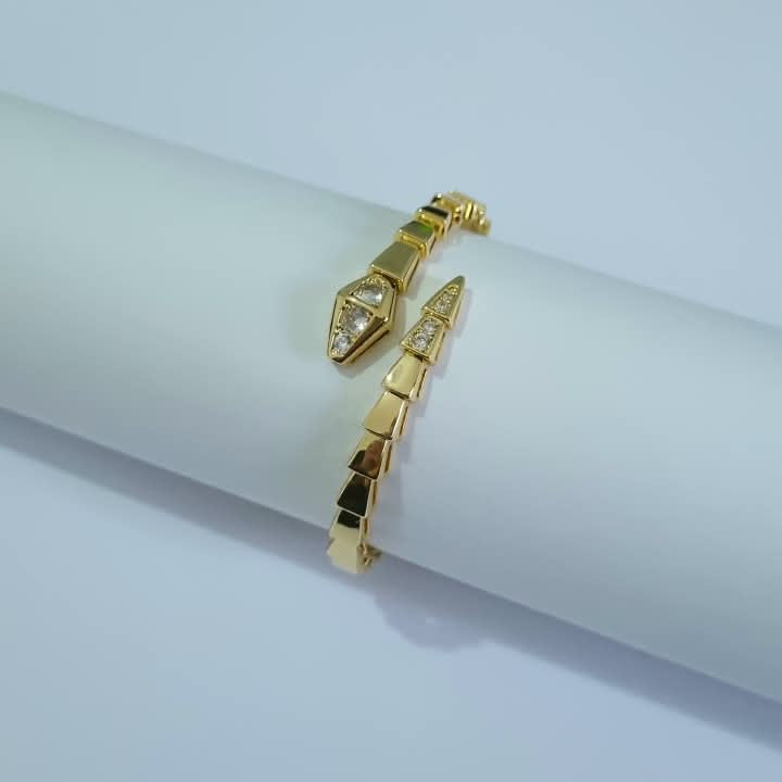 Bulgari Serpenti gold-plated wrap bracelet with cubic zirconia snake head detail, size 17, on white background
